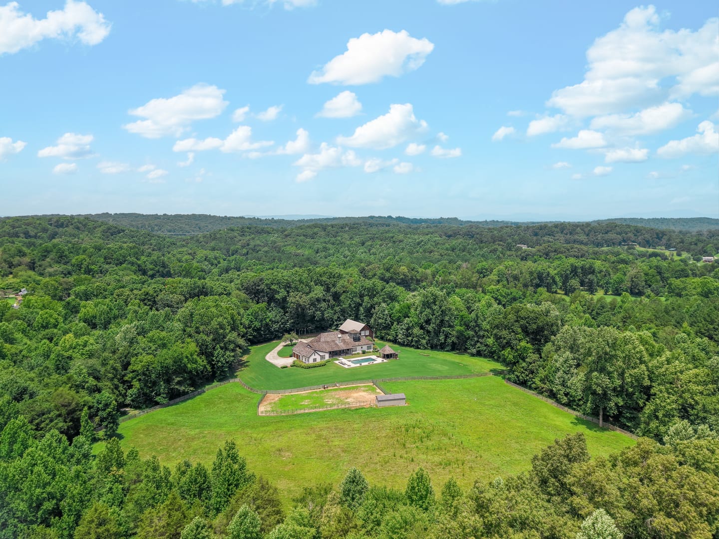 Aerial view of the estate in its clearing, surrounded by woodland