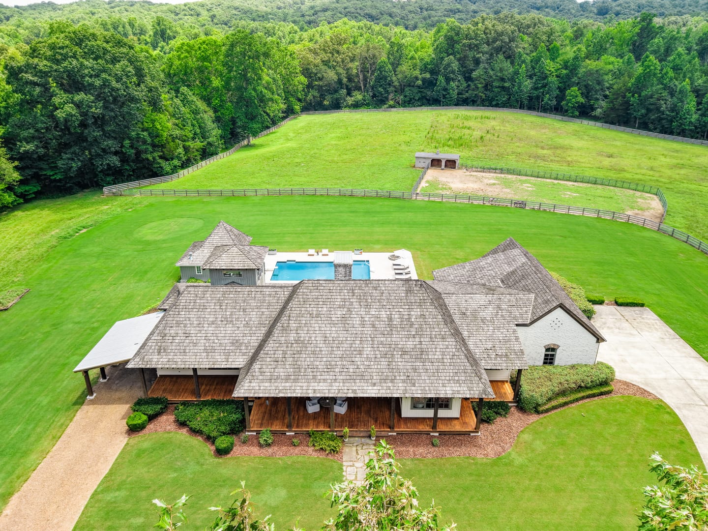 Aerial view of the main residence, pool and fenced pasture