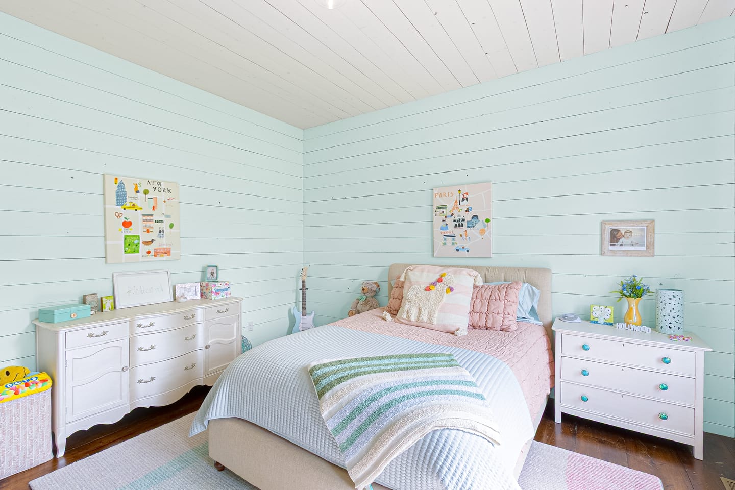 Bedroom with pale blue shiplap walls, second view