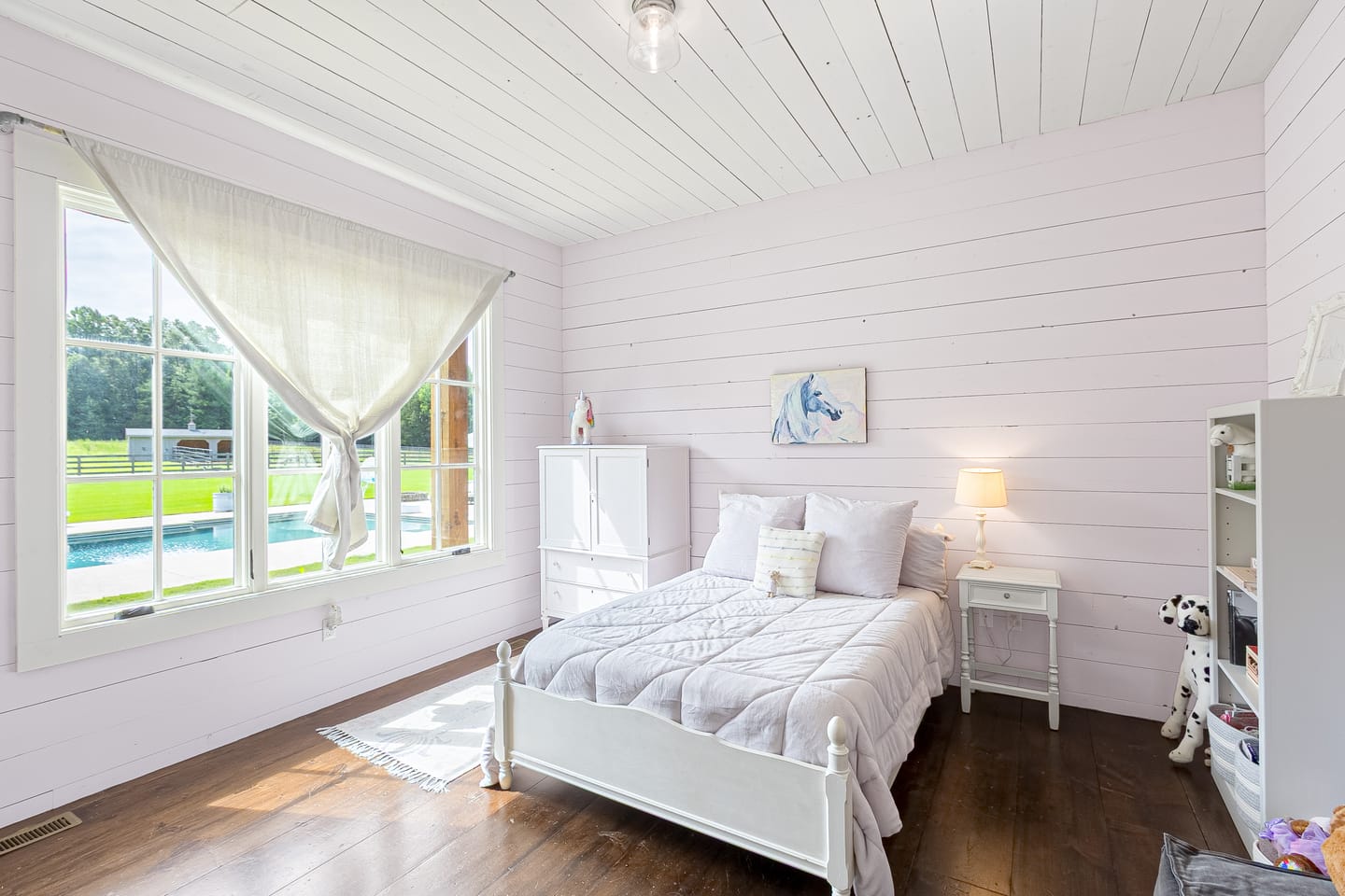 Bedroom with a window looking out to the pool