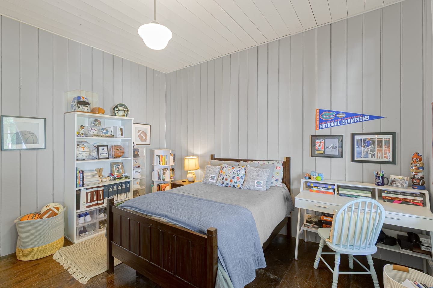 Bedroom with vertical shiplap walls, second view
