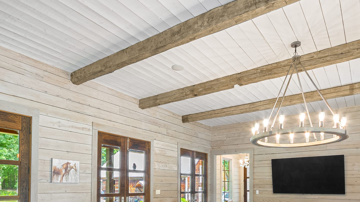 Close view of the reclaimed hand-hewn beams across the great room ceiling