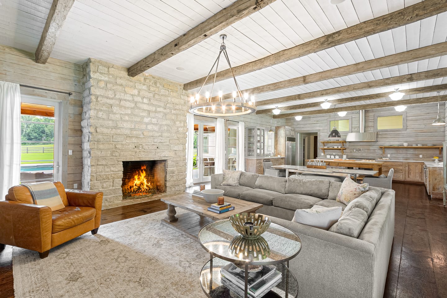 Great room fireplace and seating opening to the dining area and kitchen