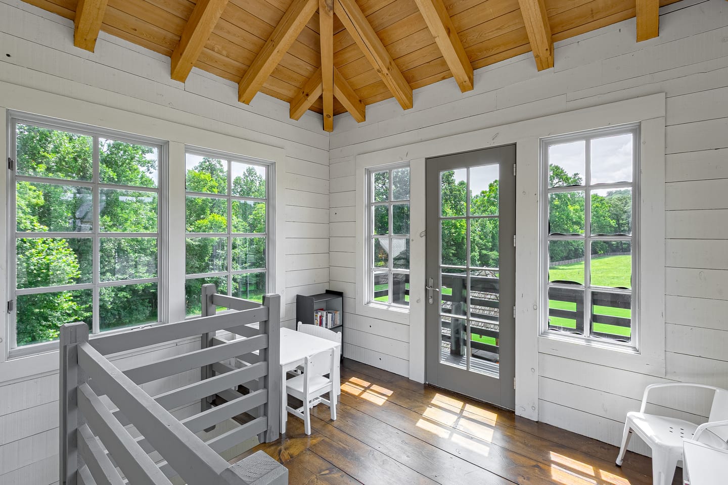 Rooftop lookout room with a vaulted wood ceiling and doors to a balcony