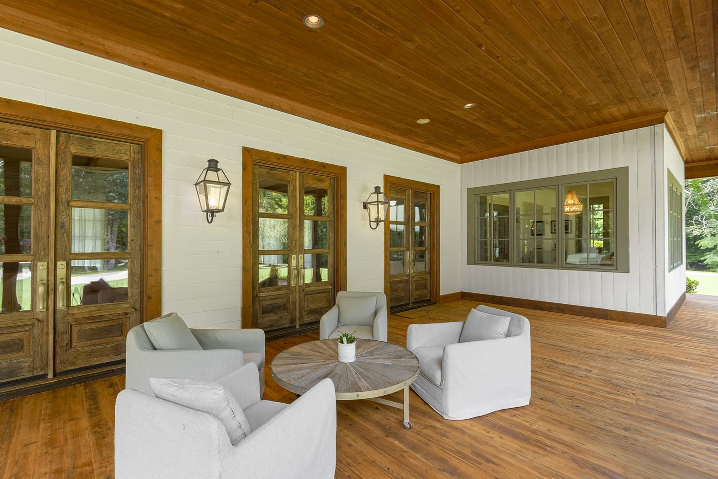 Porch sitting area under a wood plank ceiling