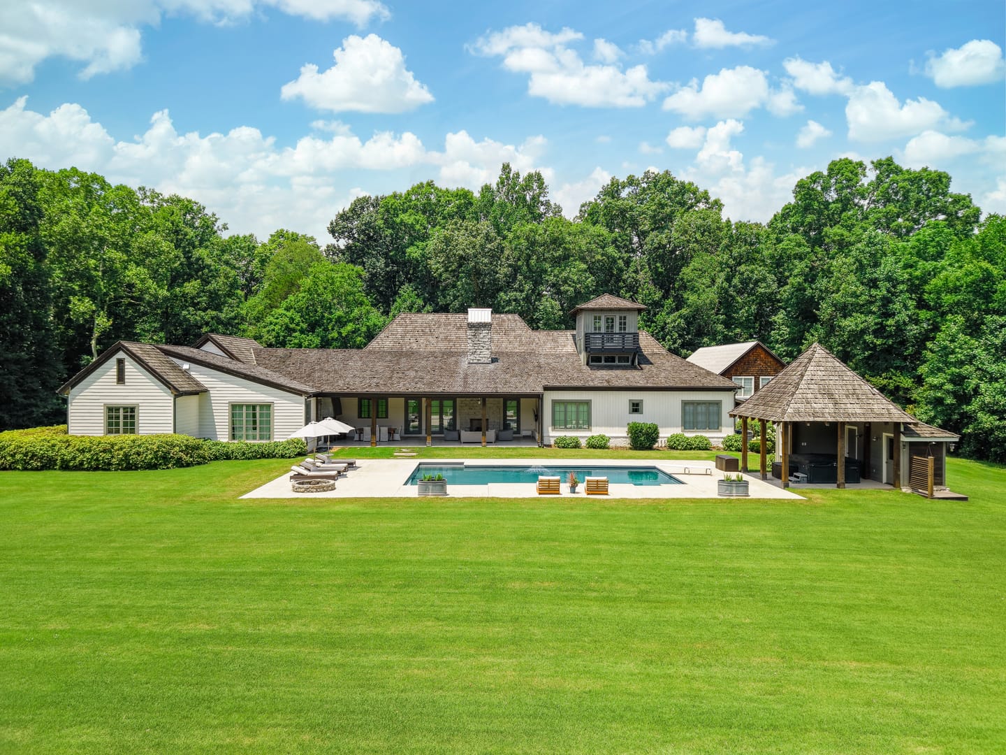 The main residence, pool and pool house across the back lawn