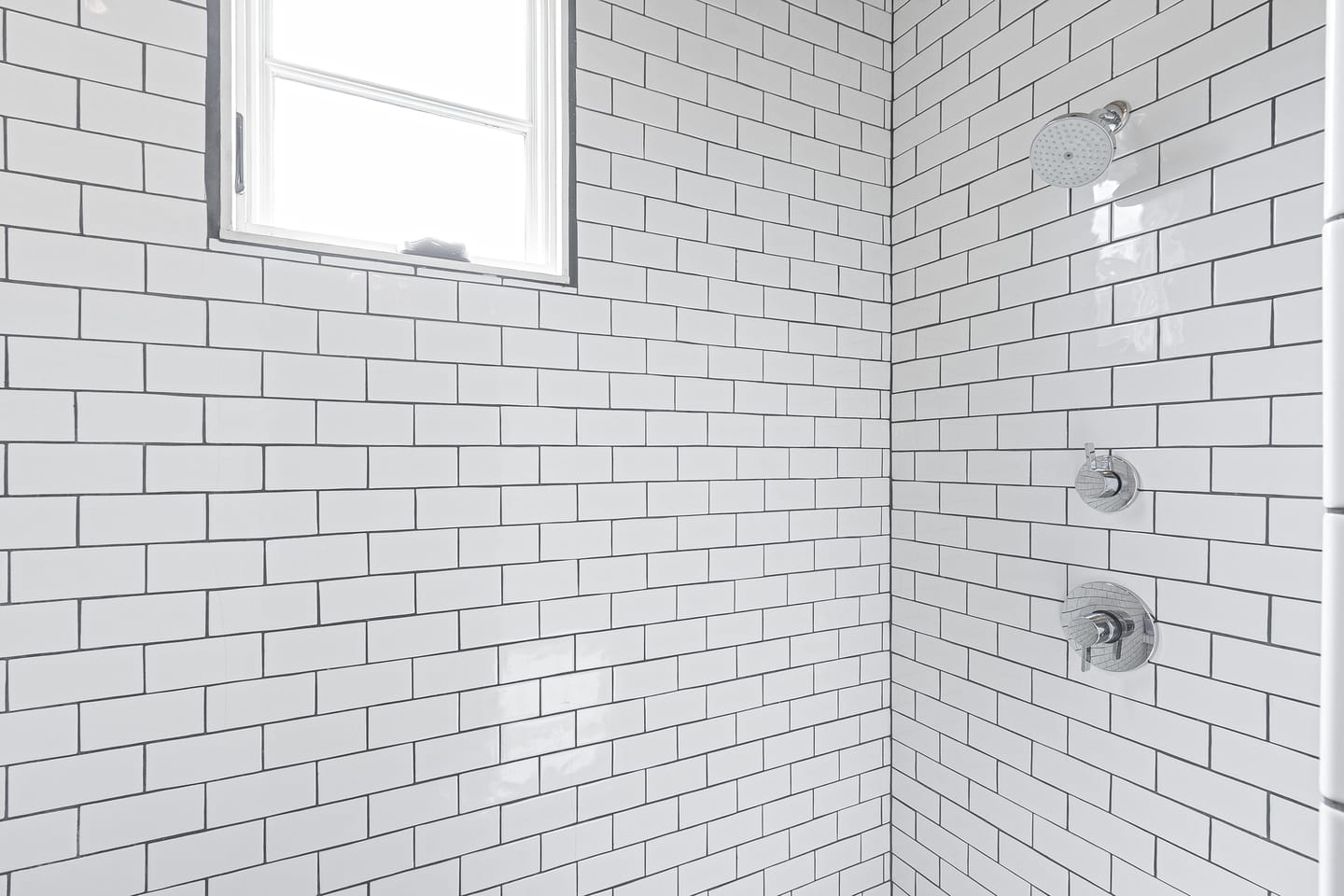Subway tile shower with a window