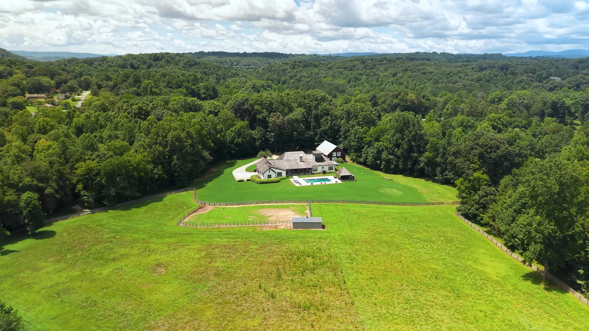 Aerial view of the estate in its clearing, surrounded by woodland